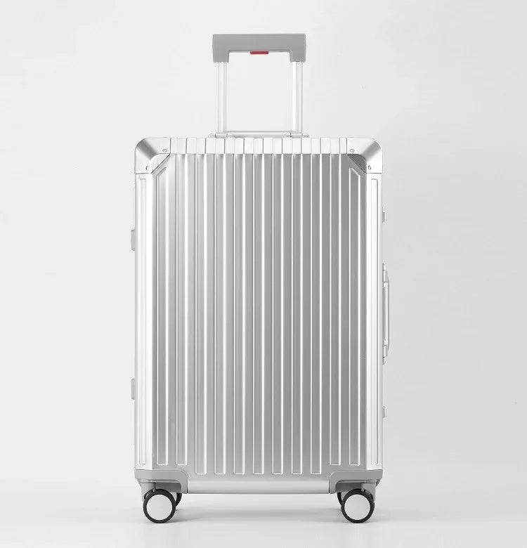 Front view of a natural aluminum hard shell suitcase with vertical grooves and spinner wheels