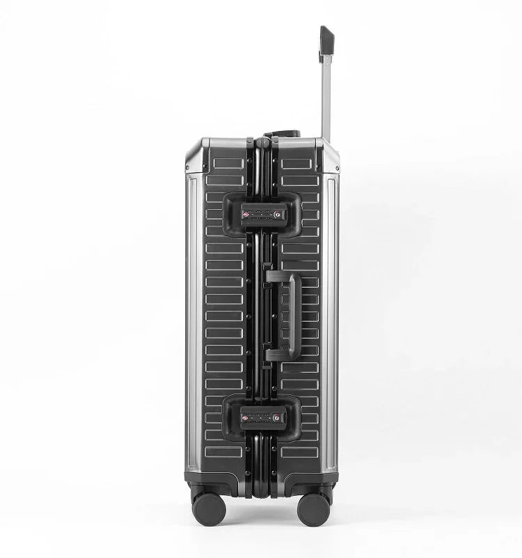 Side view of a slate grey aluminum magnesium suitcase with spinning wheels and extendable handle