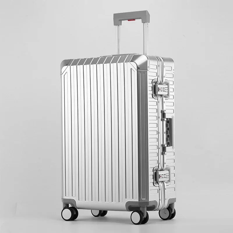 Silver hard shell luggage with wheels, retractable handle, and TSA locks against white background